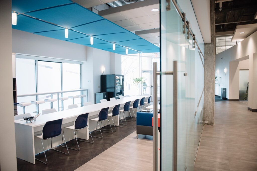Office interior with a sliding glass door and long shared worktable